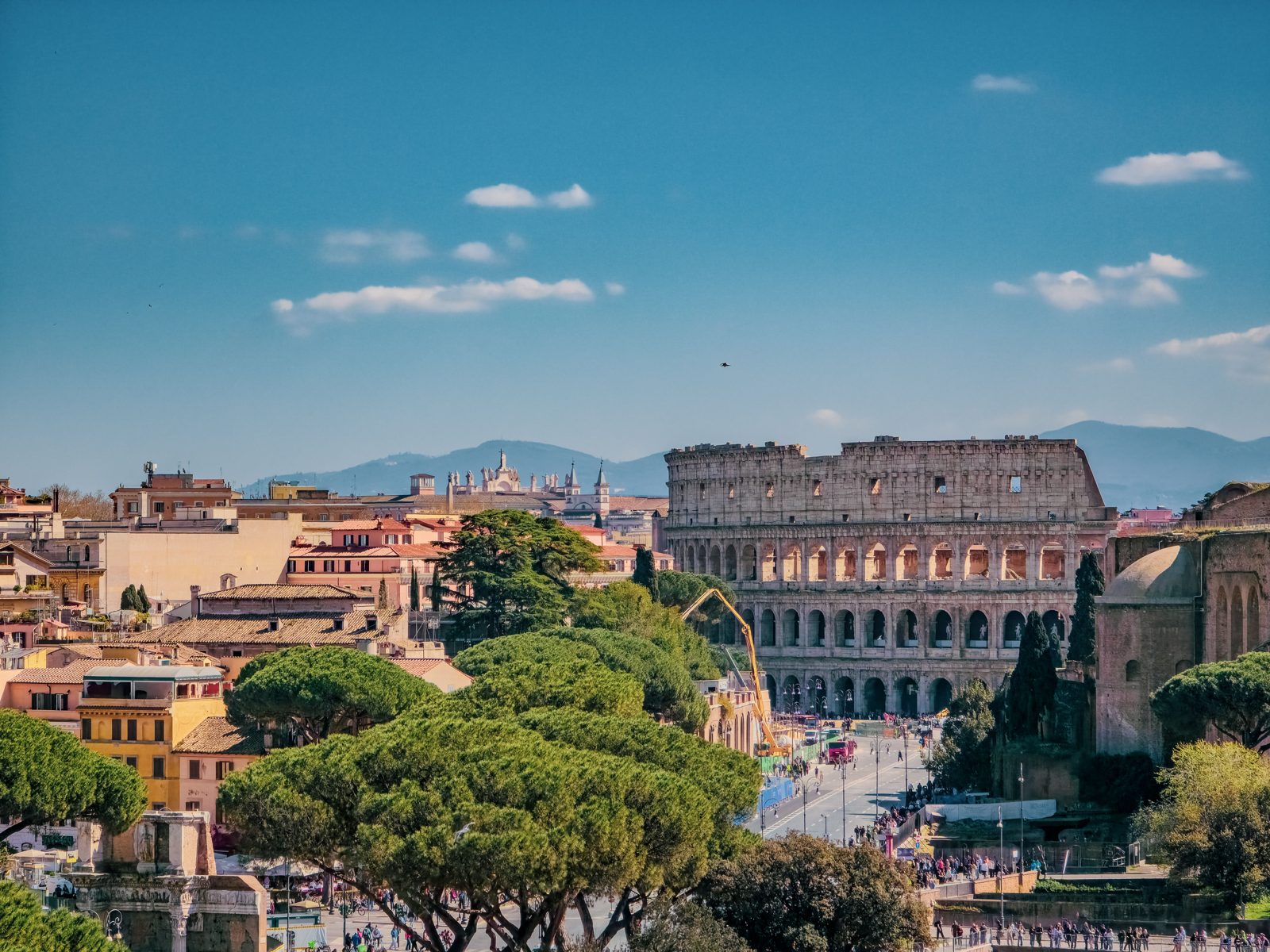 A stunning view of Rome with the iconic Colosseum on a sunny day.